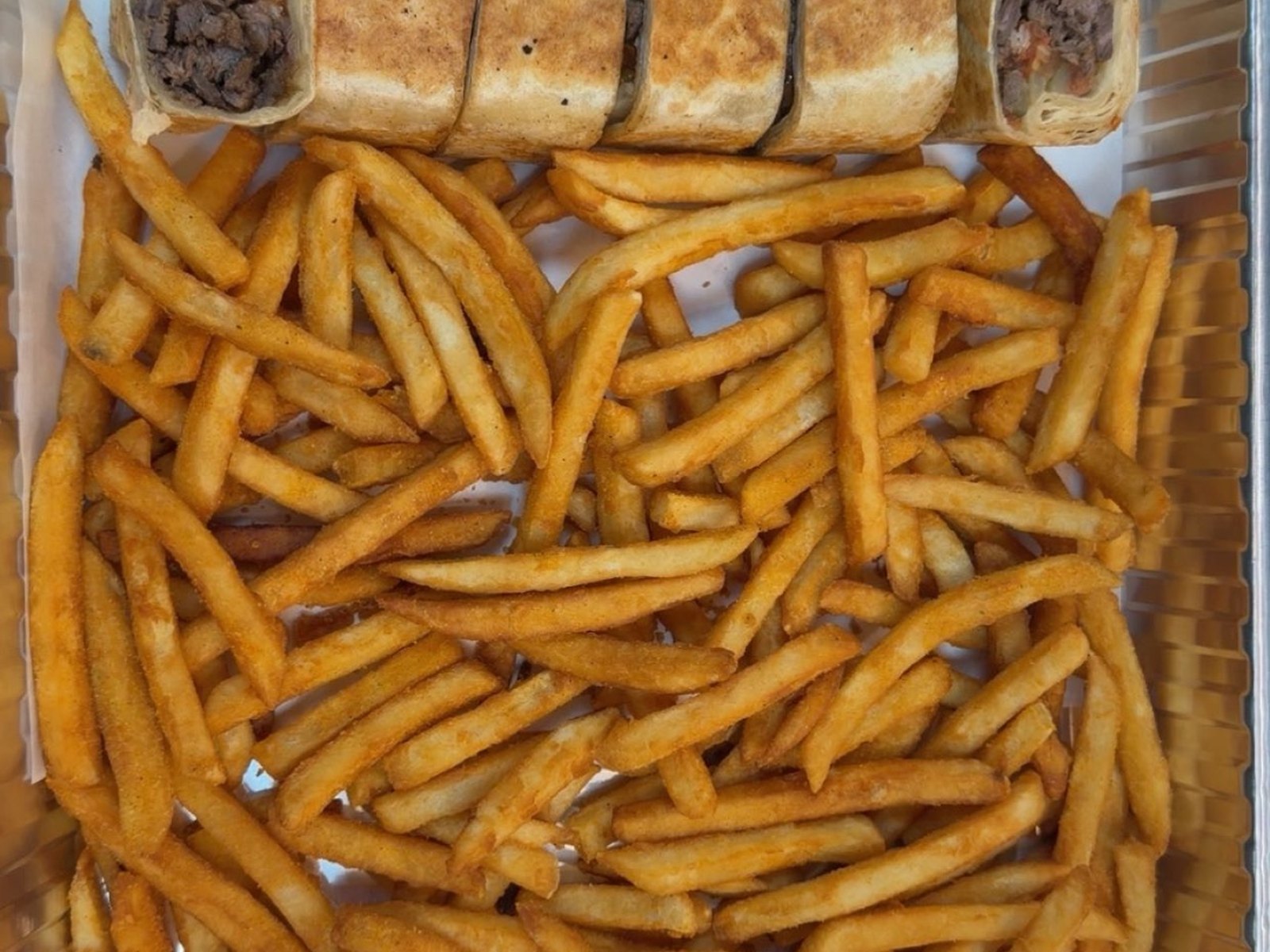 Beef shawarma rolls tray with seasoned fries and sauces