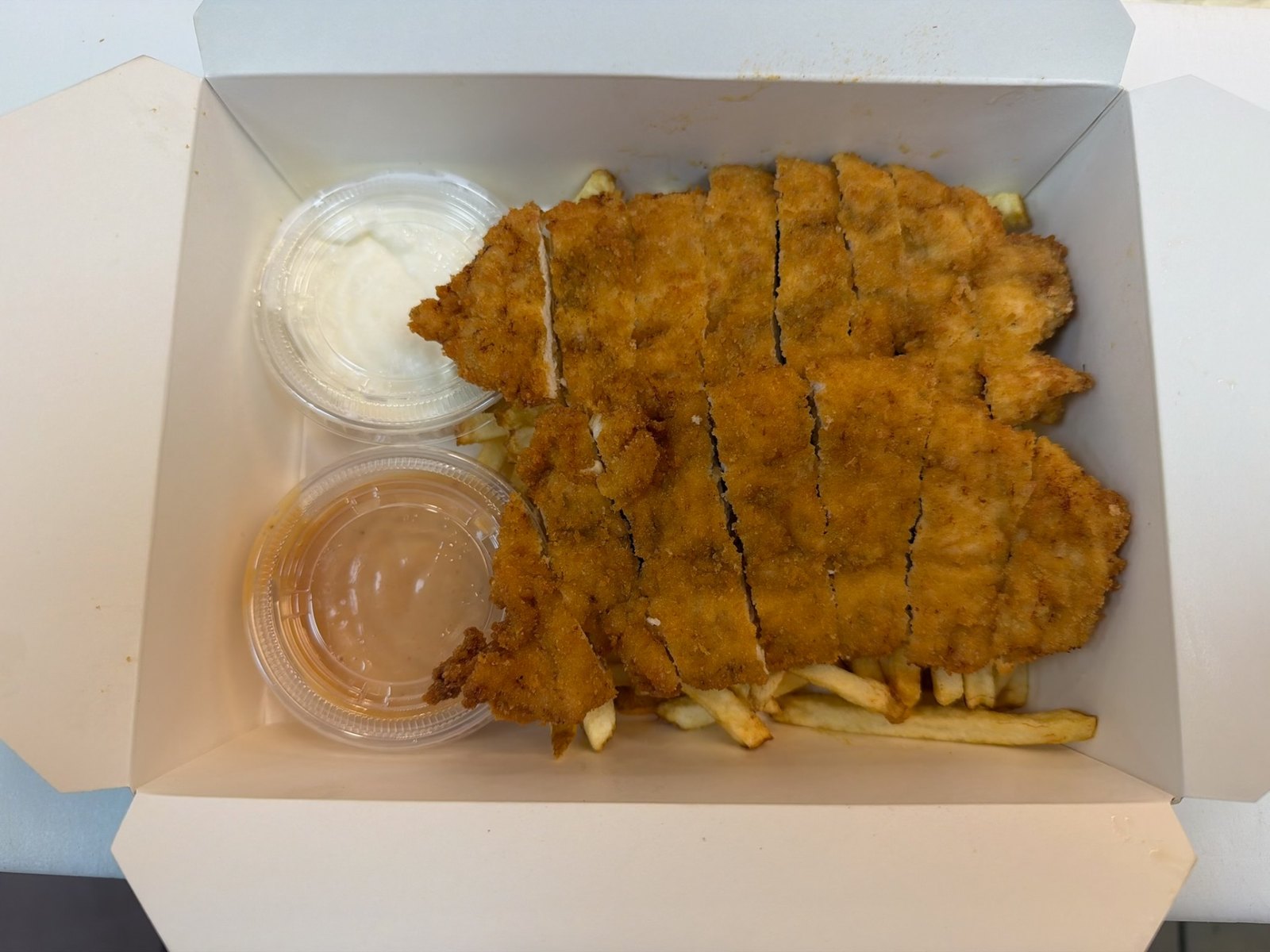 Crispy chicken escalope with fries and dipping sauces